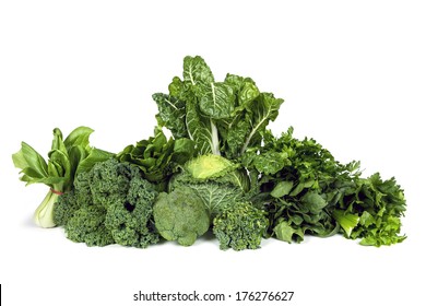 Variety of leafy green vegetables isolated on white background.