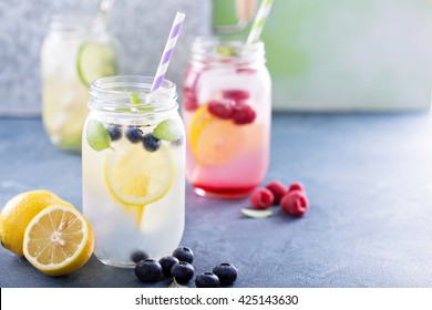 Variety of lemonade in mason jars with berries and fruits - Powered by Shutterstock