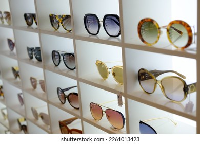 Variety of modern trendy sunglasses on showcase - Shutterstock ID 2261013423