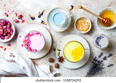 Variety of Moon Milk for a better sleep. Turmeric golden milk, pink rose milk, blue butterfly pea and lavender moon milk. Trendy relaxing bedtime drink