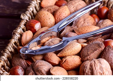 Variety of nuts with nut cracker, selective focus