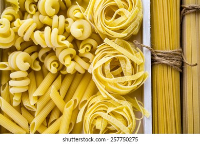 Variety og organic dry pasta on wood board. - Shutterstock ID 257750275