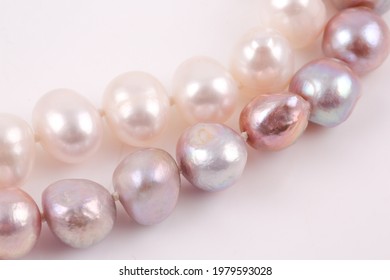 A Variety Of Pearl Strand Necklaces Photographed On A Light White Background