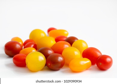 Variety of plum, grape, cherry, small tomatoes with red, orange and yellow colors with copy space to top - Powered by Shutterstock