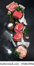 Variety of raw meat  with seasoning  on dark background. Top view 