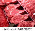 a variety of red meat cuts, likely beef, presented for sale