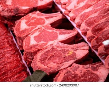 a variety of red meat cuts, likely beef, presented for sale