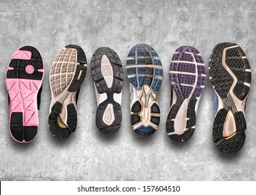 Variety Of Shoes./ Different Shoe Sole On A Grey Background. 