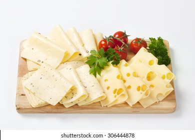 Variety Of Sliced Cheeses On  Wooden Cutting Board