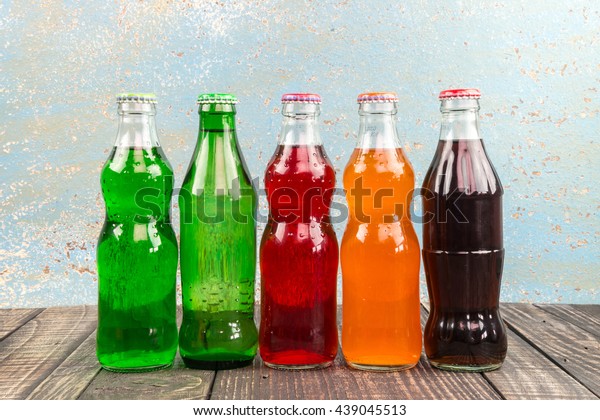 variety of soda\
bottle on the wooden\
background\
