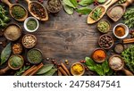 a variety of spices and herbs neatly arranged on a wooden surface. It includes whole spices like cinnamon sticks, star anise, and peppercorns