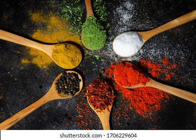 Variety of spices and herbs on black background
