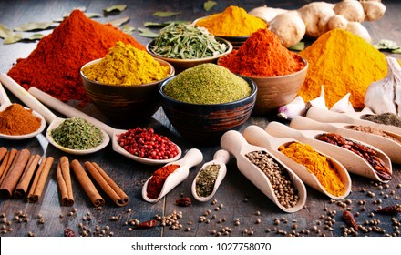Variety of spices and herbs on kitchen table. - Shutterstock ID 1027758070