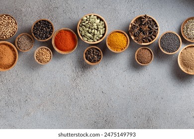 A variety of spices in wooden bowls on a gray background with copyspace top view - Powered by Shutterstock