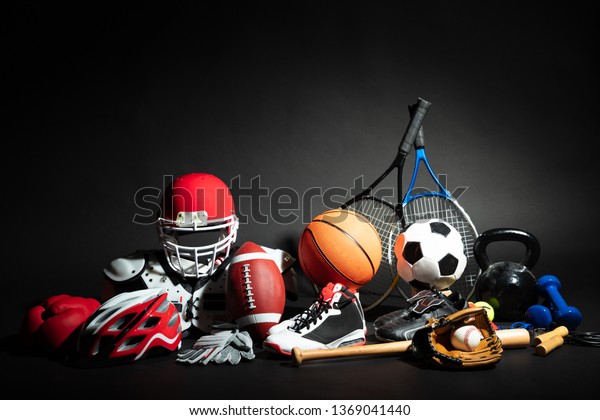 Variety Of Sport Balls And Equipment In Front Of\
Black Surface
