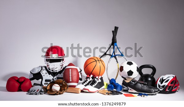 Variety Of Sport Balls And Equipment In Front Of\
Gray Surface