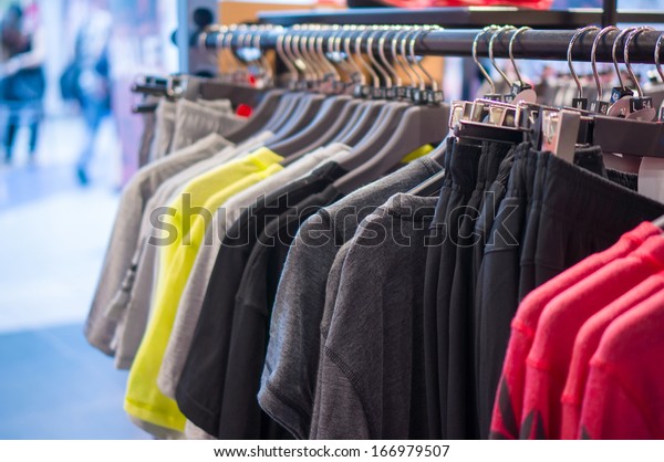 Variety\
of Sport t-shirts and trousers  on stand in\
store