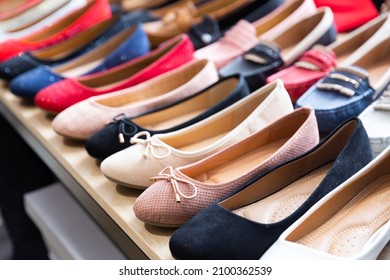 Variety Of Stylish Comfortable Multicolored Suede Ballet Flats Offered For Sale On Shelf In Shoe Store. Womens Shoes Collection