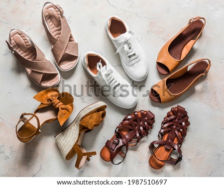 Variety of summer women's shoes - sneakers, sandals, roman sandals, slippers on a light background, top view        
