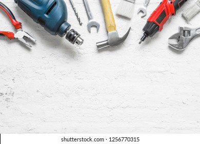 variety of tools for a constructions worker on the grunge white wooden background