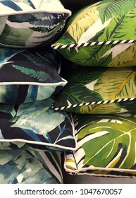 Variety Of Tropical Patterned Cushions Stacked, On Display For Sale.