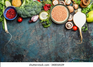 variety of vegetables, red lentil and ingredients for healthy cooking on rustic background, top view, horizontal border. Vegan food or diet eating concept. - Powered by Shutterstock