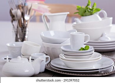 Variety of white dinnerware: plates, cups and bowls