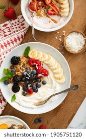 Variety Of Yogurt Bowls With Strawberry And Plain Yogurt, Fruit And Granola