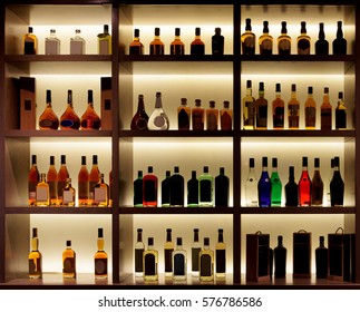 Various alcohol bottles in a bar, back light, all logos removed
