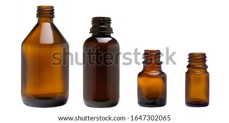 various amber glass bottles for cosmetics, natural medicine, essential oils or other liquids isolated on a white background