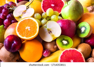 Various assorted juicy fruits: kiwi, orange, apple, grapes, grapefruit