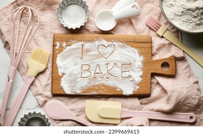 various baking tools and flour on pink napkin, top view, I love bake - Powered by Shutterstock