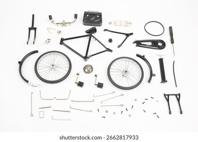 Various bicycle components are systematically laid out on a clean white surface, showcasing wheels, frame, forks, and other essential parts necessary for construction or maintenance.