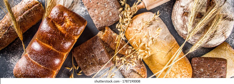 Various bread set. Many different wheat, grain and rye bread with ears of rye and wheat, flour and baker's tools on a white wooden background