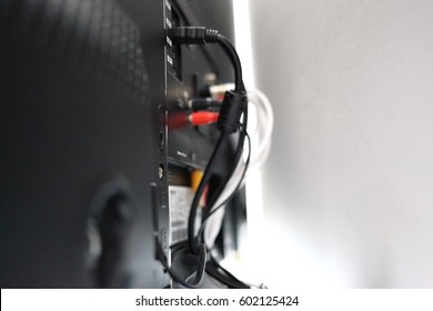 Various cables in the back of a LCD TV