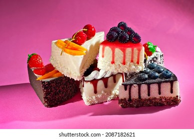 Various cakes on a pink background. Triangular pieces of cake on a paper background. Sweets on a pile close up. - Shutterstock ID 2087182621