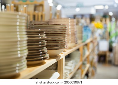 Various ceramic plates for sale in tableware department of home furnishings store..