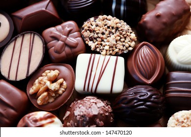 various chocolates as a background - sweet food - Shutterstock ID 147470120