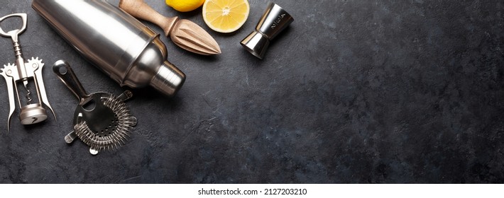 Various cocktail utensil set. Shaker, strainer, juicer. Top view flat lay with copy space
