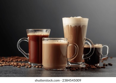 Various coffee and chocolate drinks with scattered coffee beans on a black table. - Powered by Shutterstock