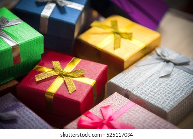 Various Color Of Christmas&happy New Year Gift Boxes Stack, Reward Holiday Presents Greeting Celebration Card Concept Background, Selective Focus, 45 Degree Angle View.