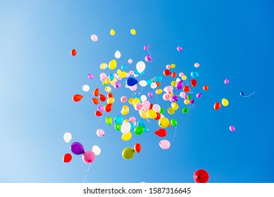 Various Color many balloons at cloudy blue sky.