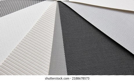 various color of roman or roller blind samples, close up or macro view. interior curtain samples in light color tone for selection. manufacture of fabric blinds for sun protection. modern curtain. - Shutterstock ID 2188678573
