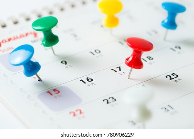 Various Color Thumb Tack Pins On Calendar As Reminder