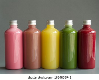 Various colored juices in plastic bottles