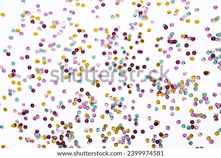 Various colored sequins on a white background. Decorative accessories for sewing and embroidery. Circle shape shining paillettes. Template for card, invitation. Top view