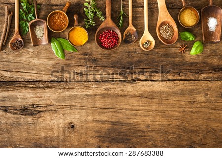 Various colorful herbs and spices on wooden table