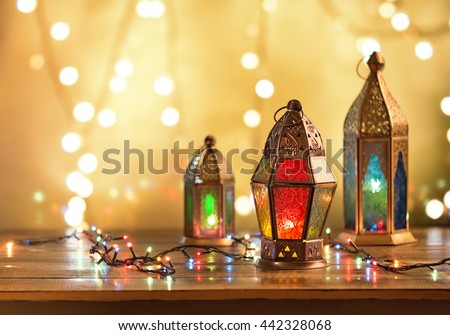 Various colorful Ramadan lamps lit up against illuminated decorative lighting background.