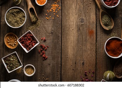 Various Colorful Spices On Wooden Table. Place For Typography And Logo