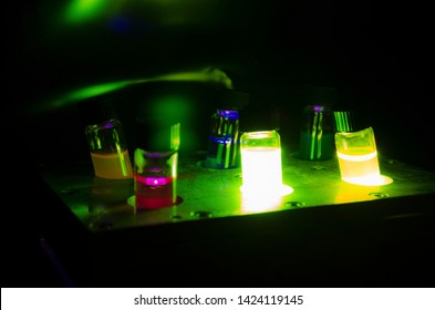 Various Colourful Light Induced Catalyst Photochemical Reaction In Glass Vials Under Green Light In A Dark Chemistry Laboratory For Biomedical Research